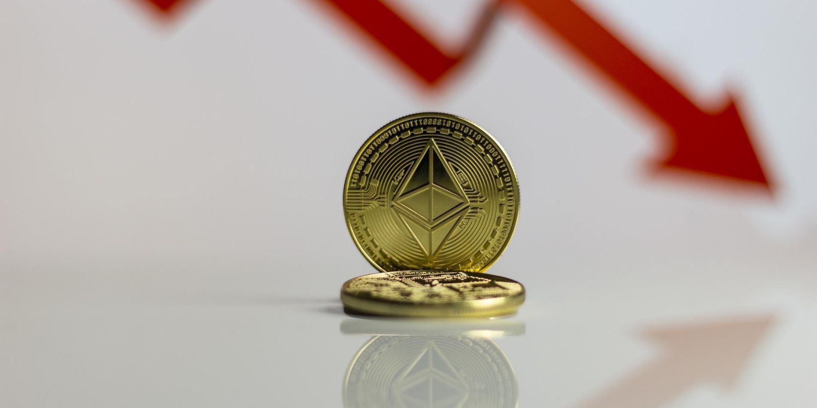 ethereum coin in front of downward arrow