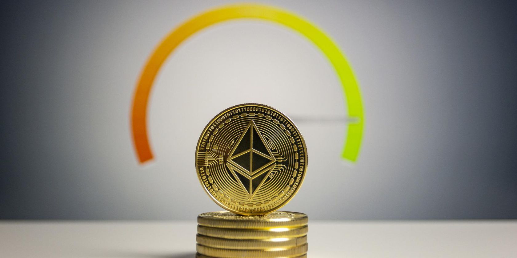 stack of ethereum coins in front of meter
