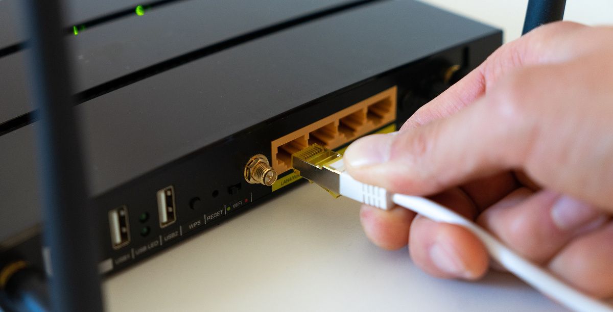 an ethernet cable being plugged into a router