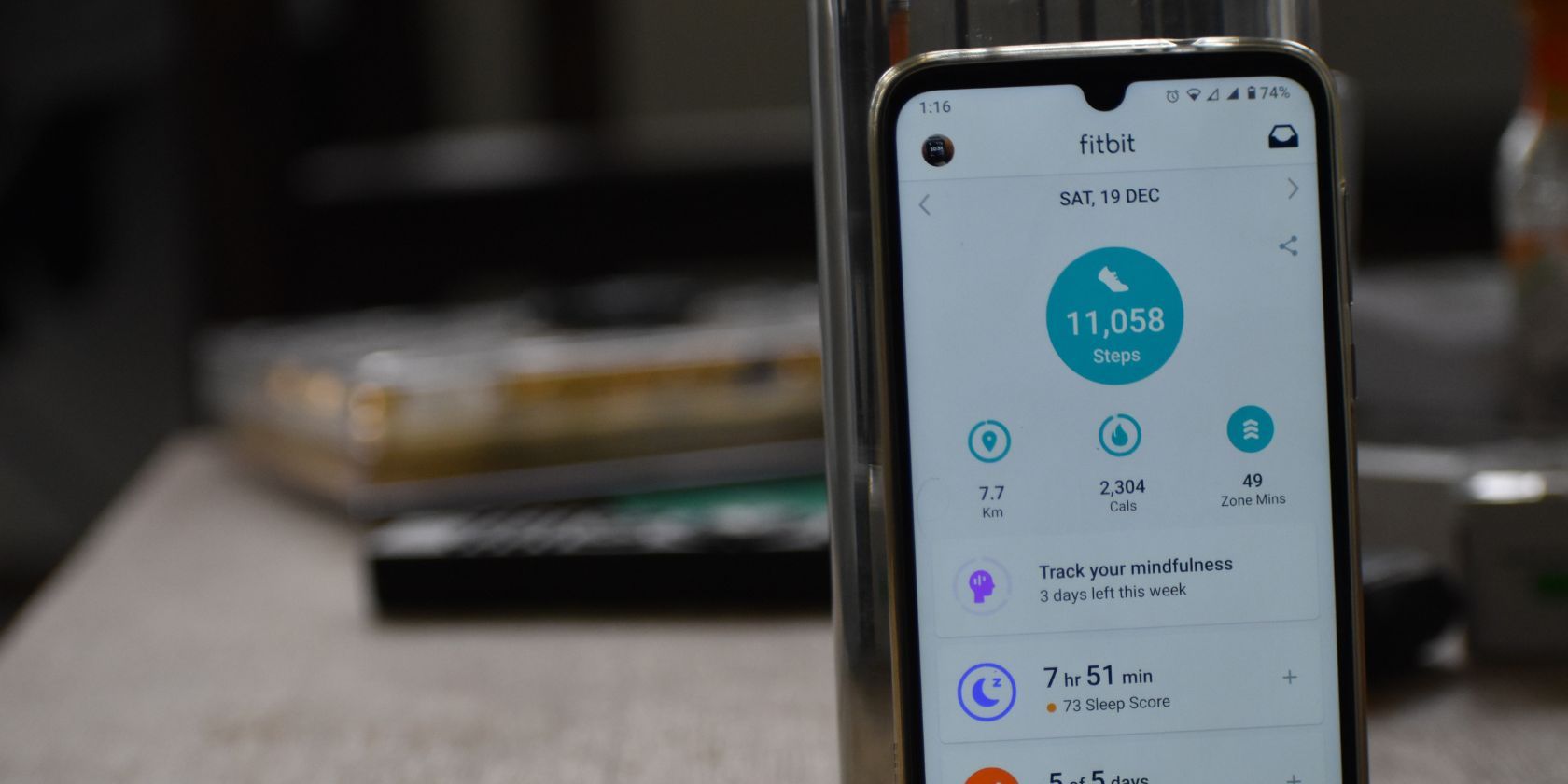 fitbit app pulled up on a smartphone showing over 11,000 steps in a day