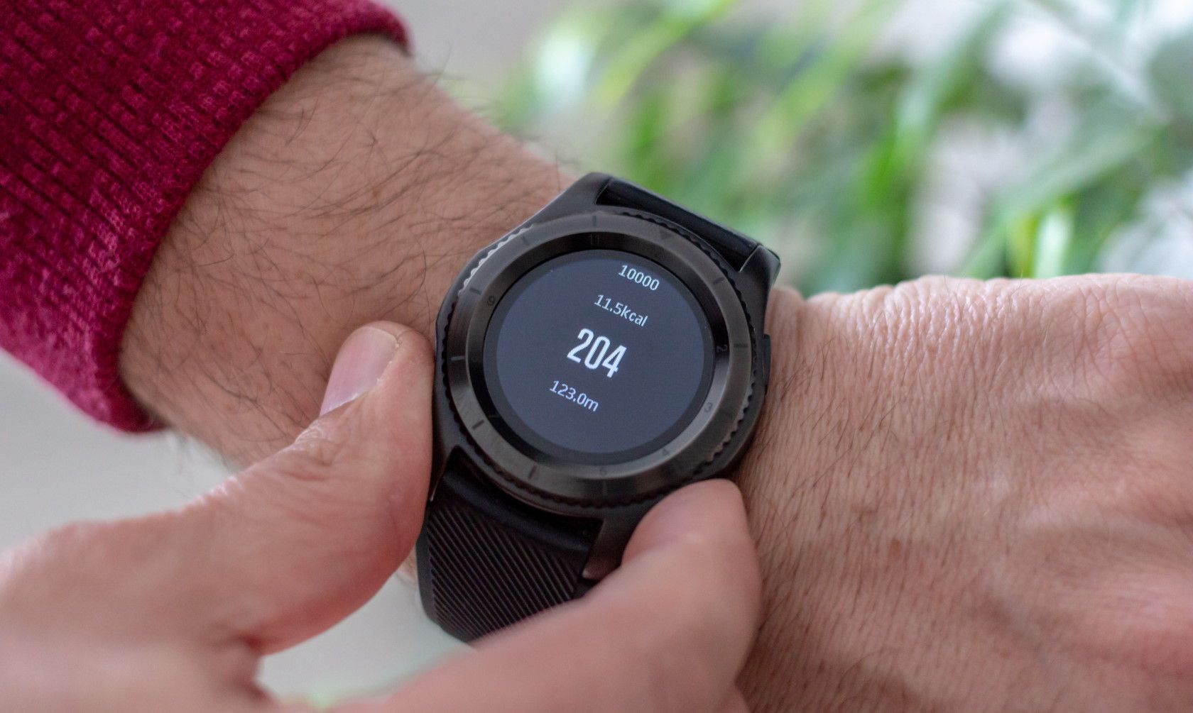 person using fitness tracker smart watch to count calories