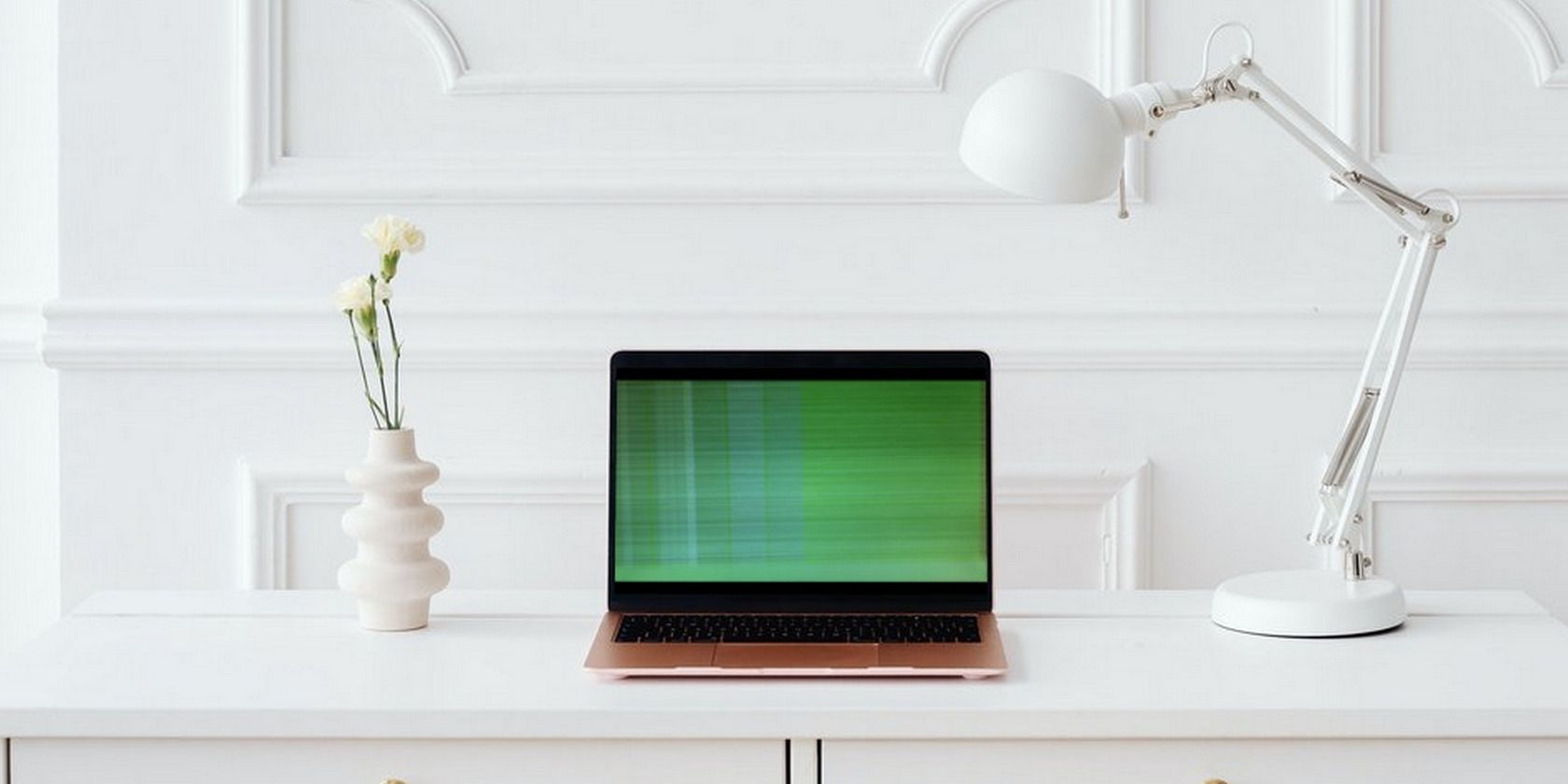 Green lines on a laptop sitting on a table