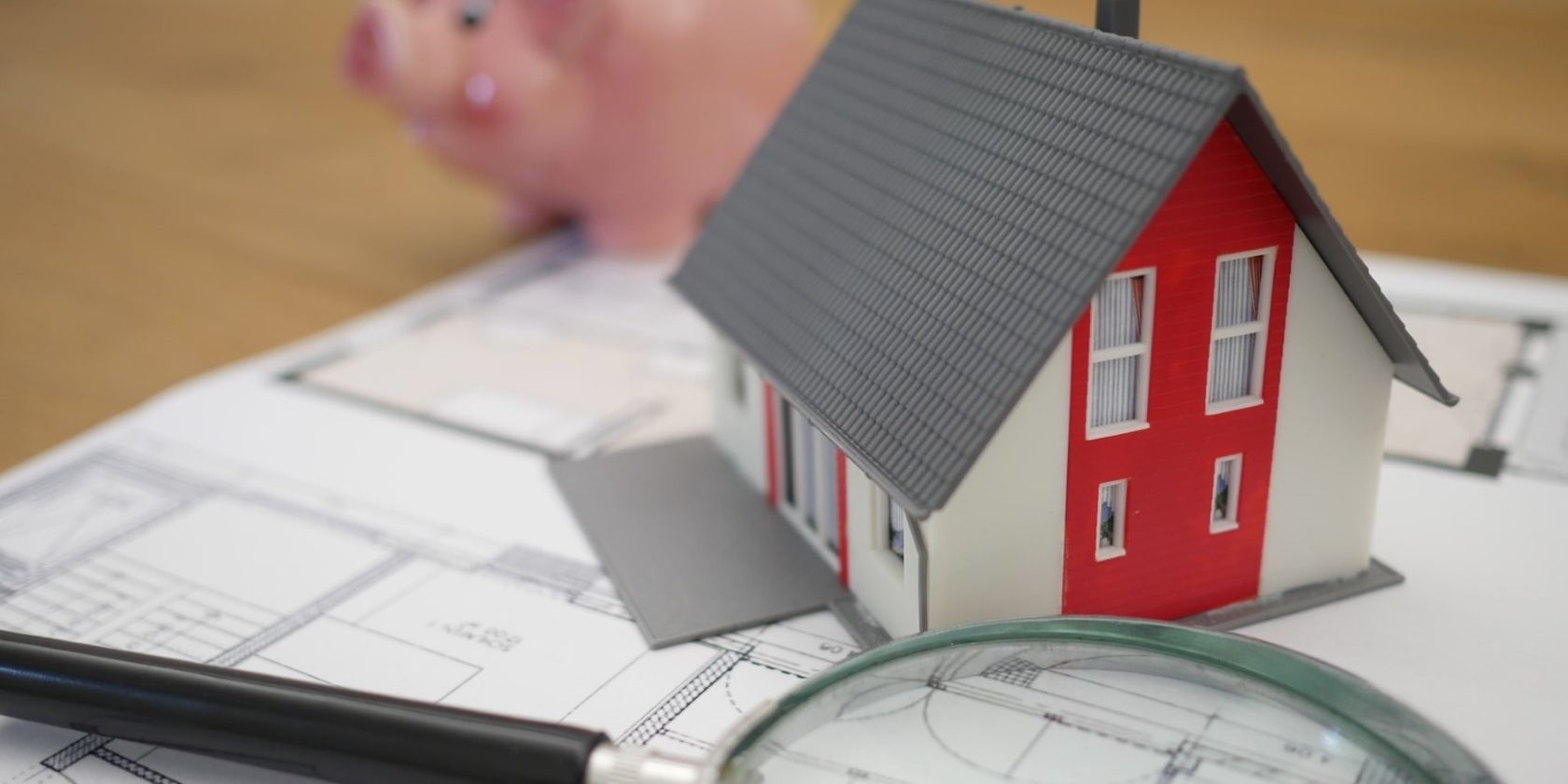 house model with magnifying glass and piggy bank