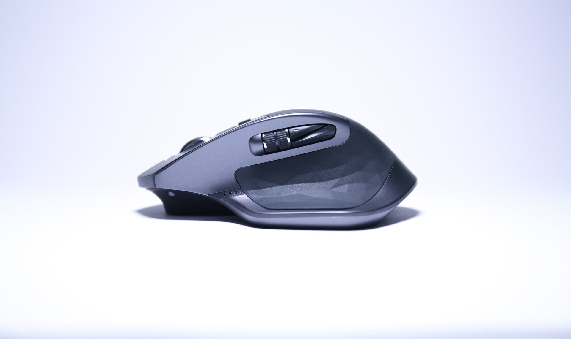 logitech mx master 2s wireless mouse against white background battery indicator lights on side