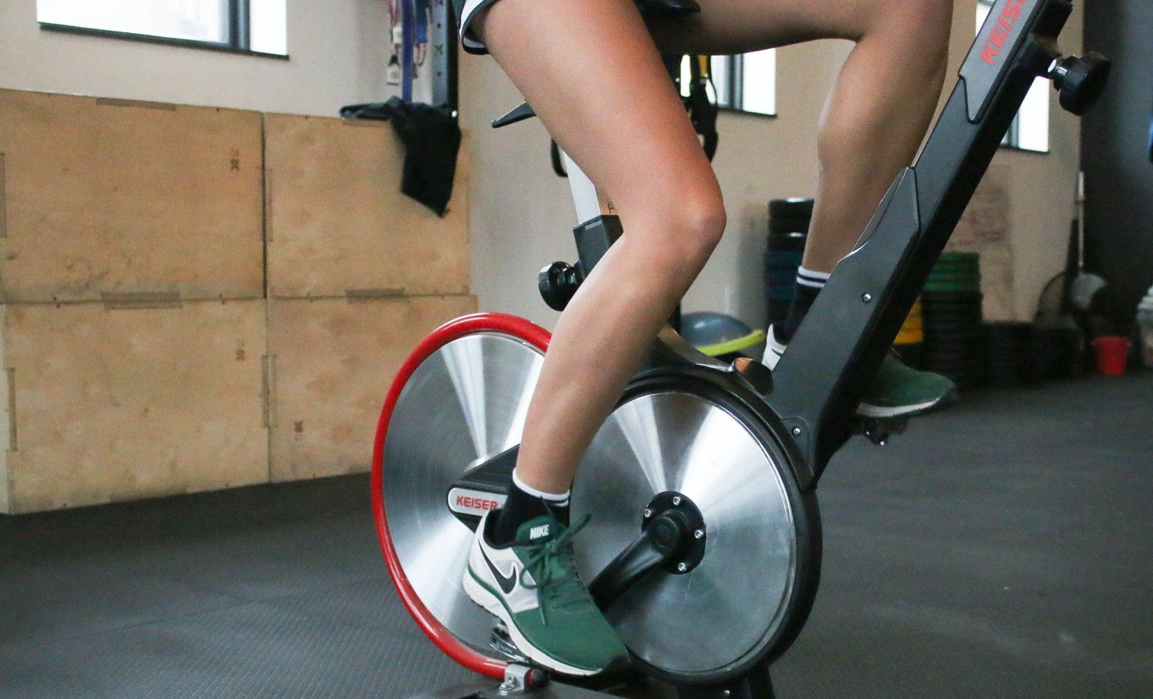 Person exercising on indoor exercise bicycle in gym