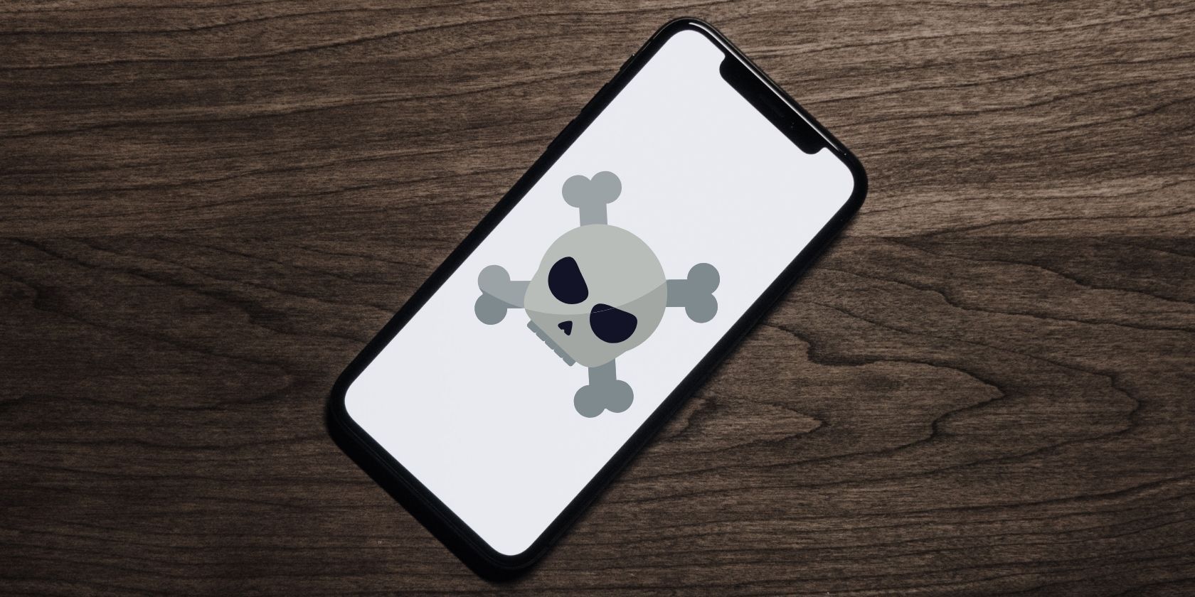 logo tengkorak dan tulang di layar ponsel
