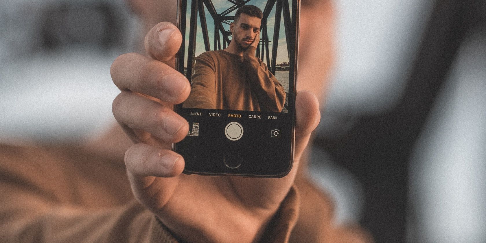 man taking photo with iPhone