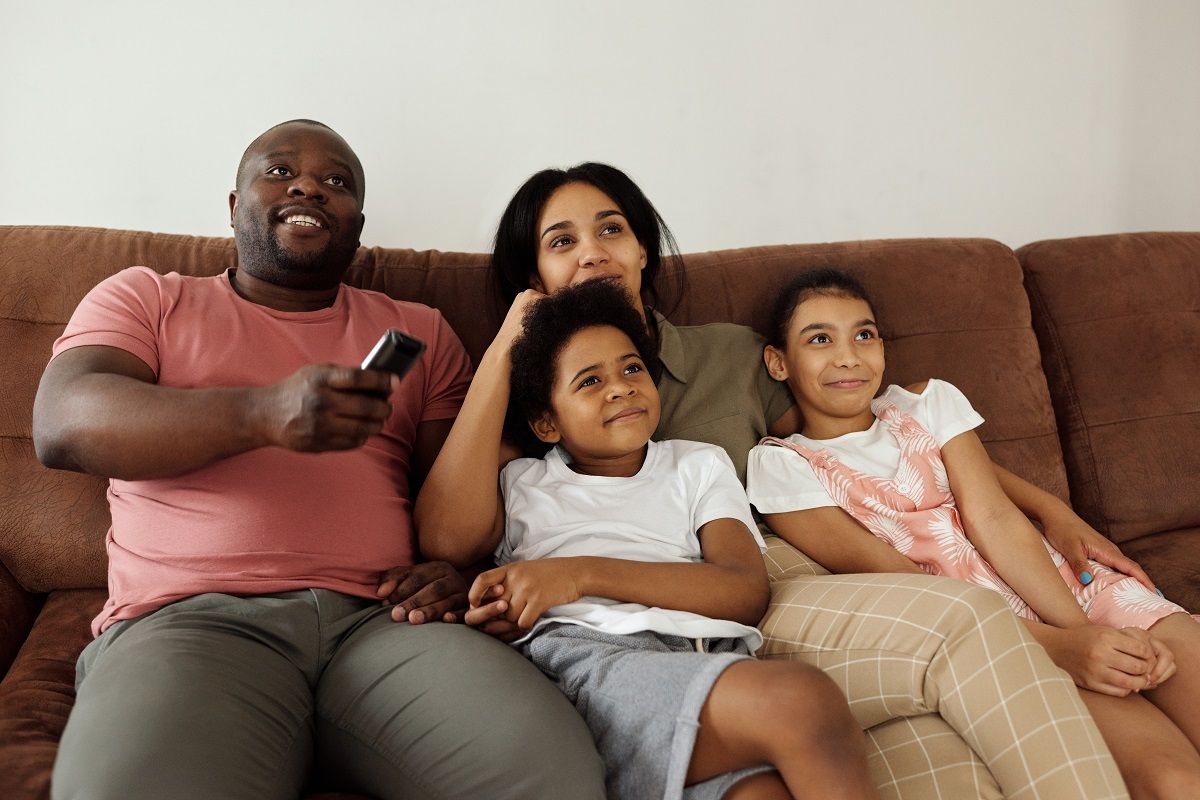 Happy Indian Man African Woman Relaxing Daughter Son Watching Television  Stock Photo by ©ridofranz 406599806
