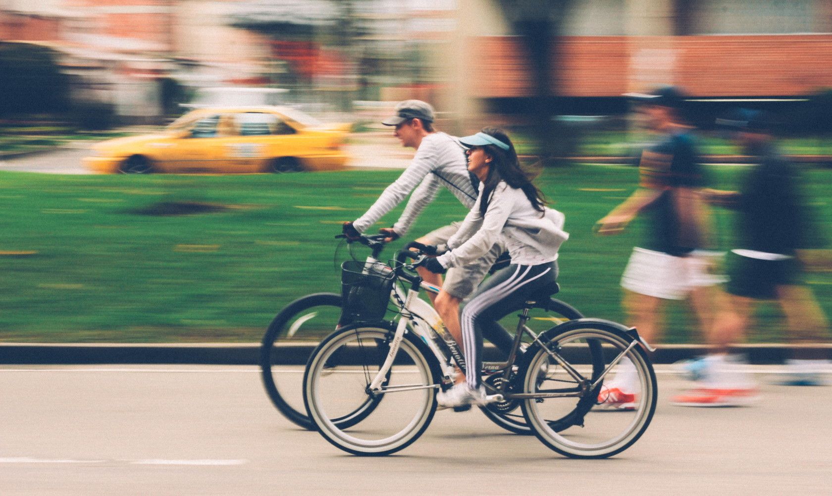couple cycling outdoors in busy street