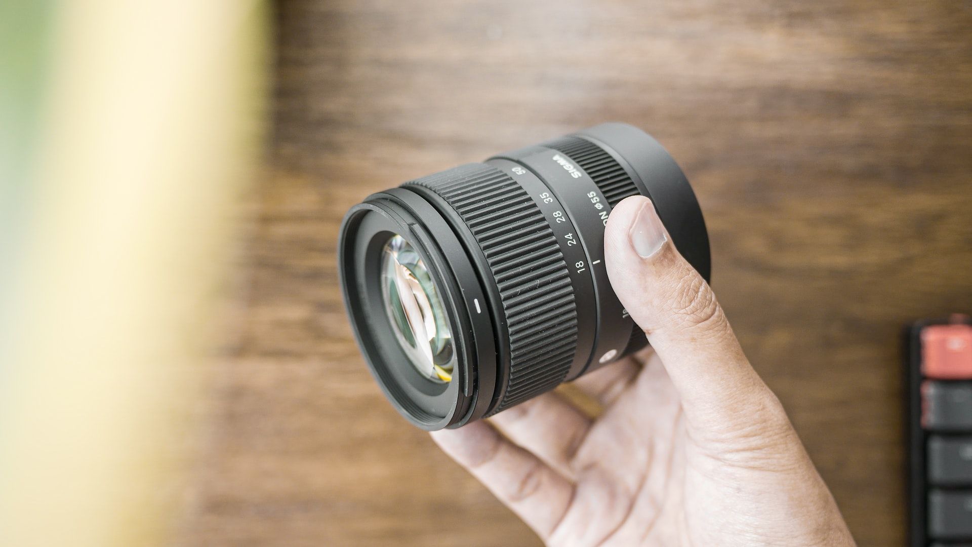 sigma 18-50mm f/2.8 lens being held