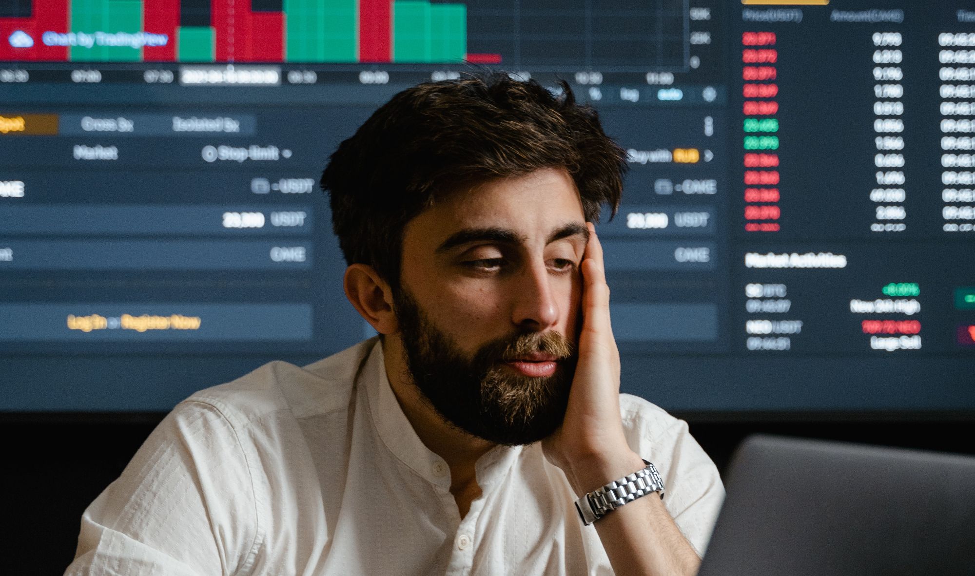 stressed man in front of exchange screen 