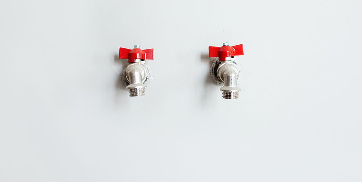 two tap heads on a white wall
