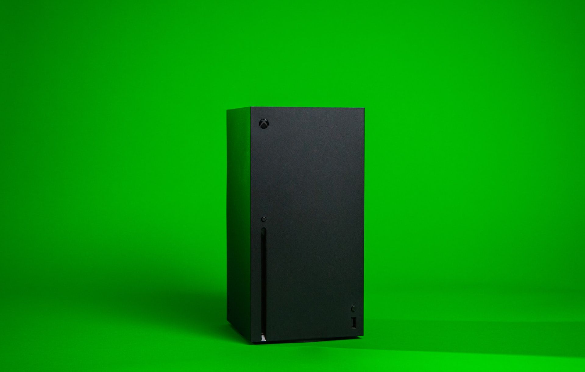 Xbox console in front of a green background