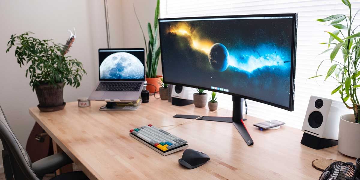 Mac desk setup with external monitor and speakers