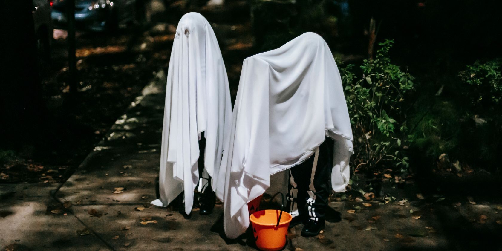 Faceless kids in phantom costumes on Halloween night in town