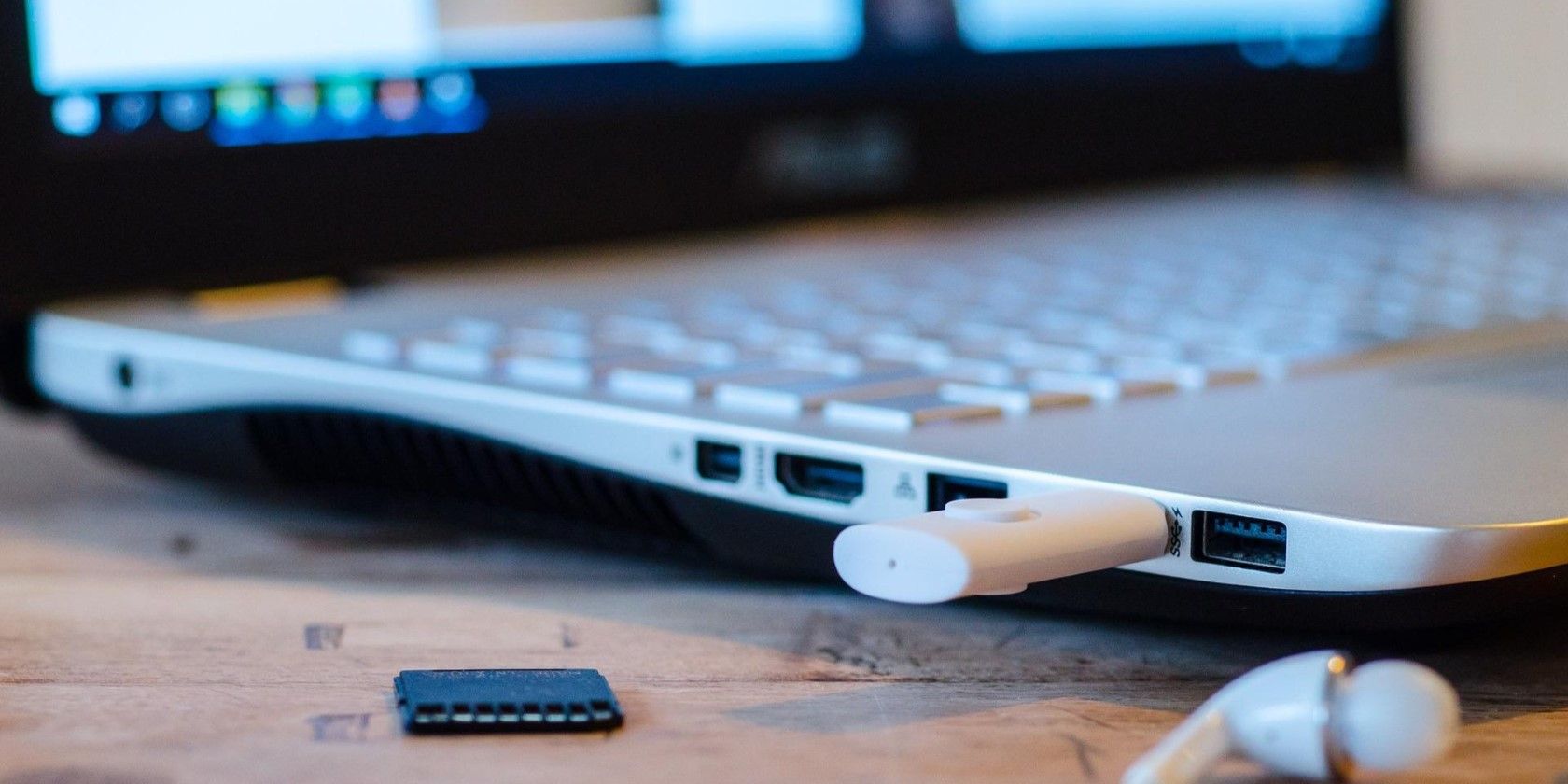 یک لپ تاپ ویندوزی روی یک میز با یک USB متصل شده است