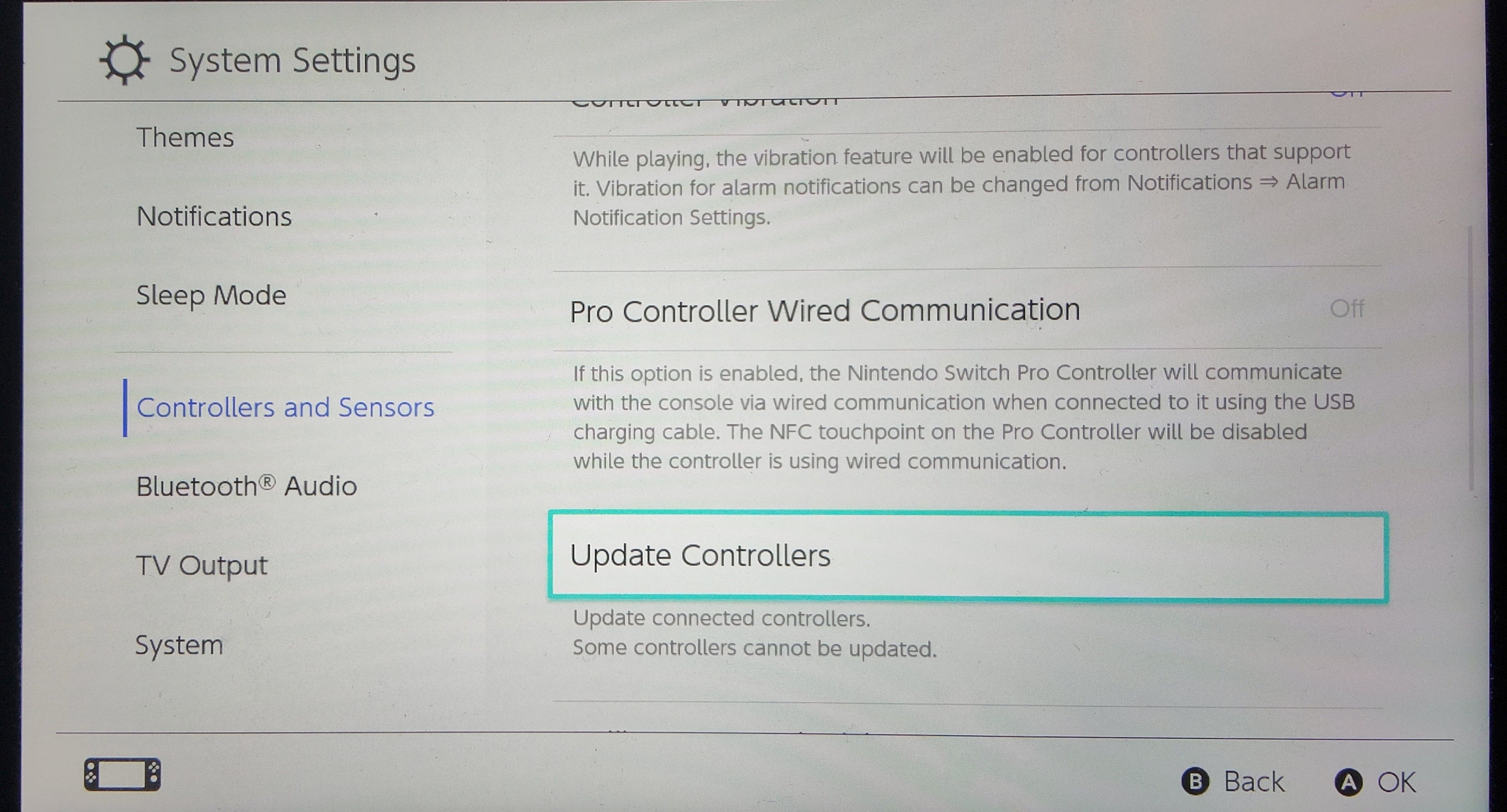 A photo of the Nintendo Switch System Settings with Update Controllers highlighted