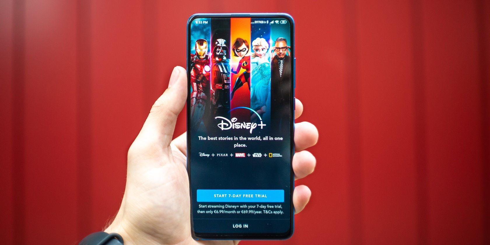 Person holding phone with Disney plus featured