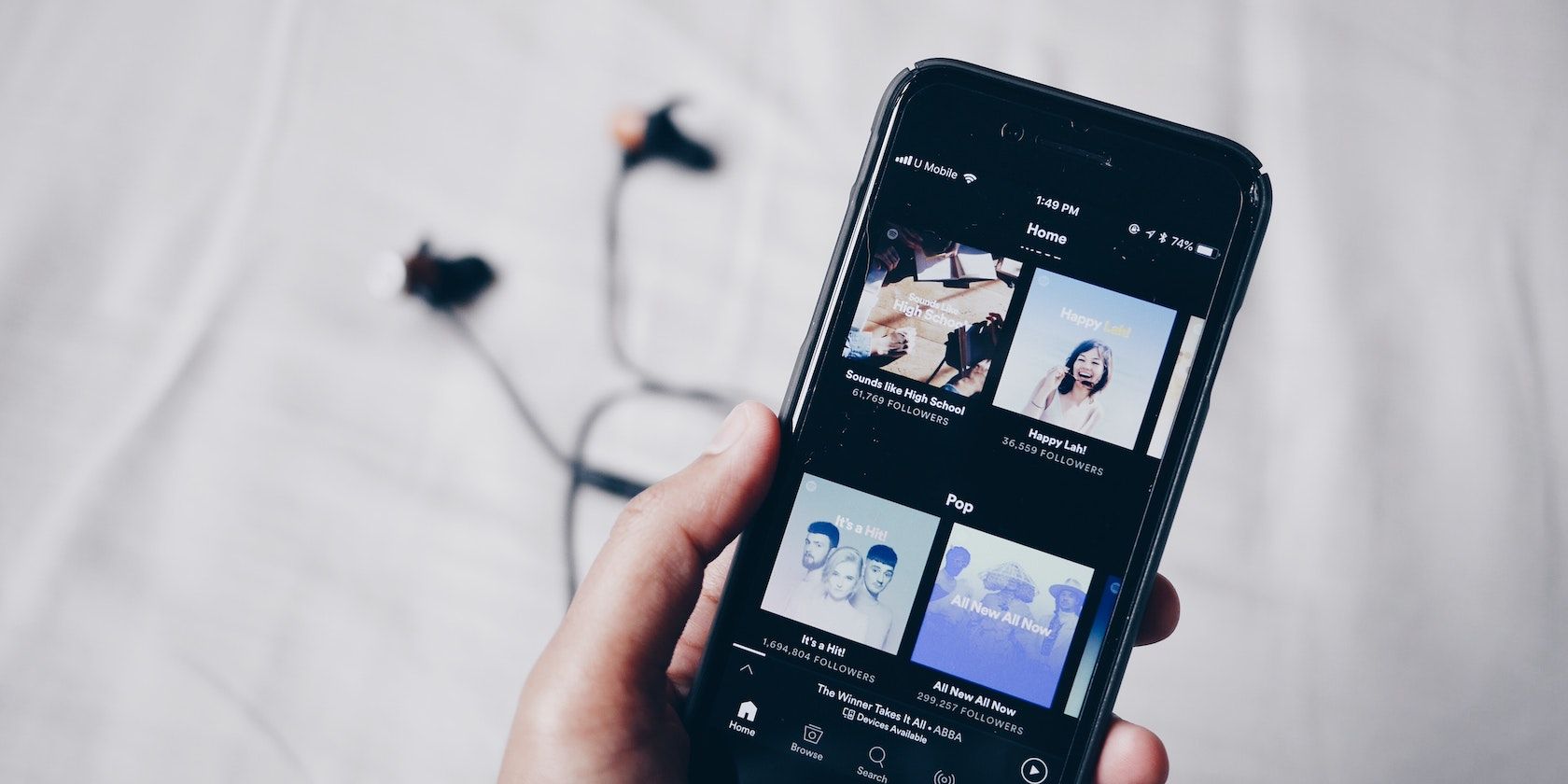 Person holding phone with Spotify featured