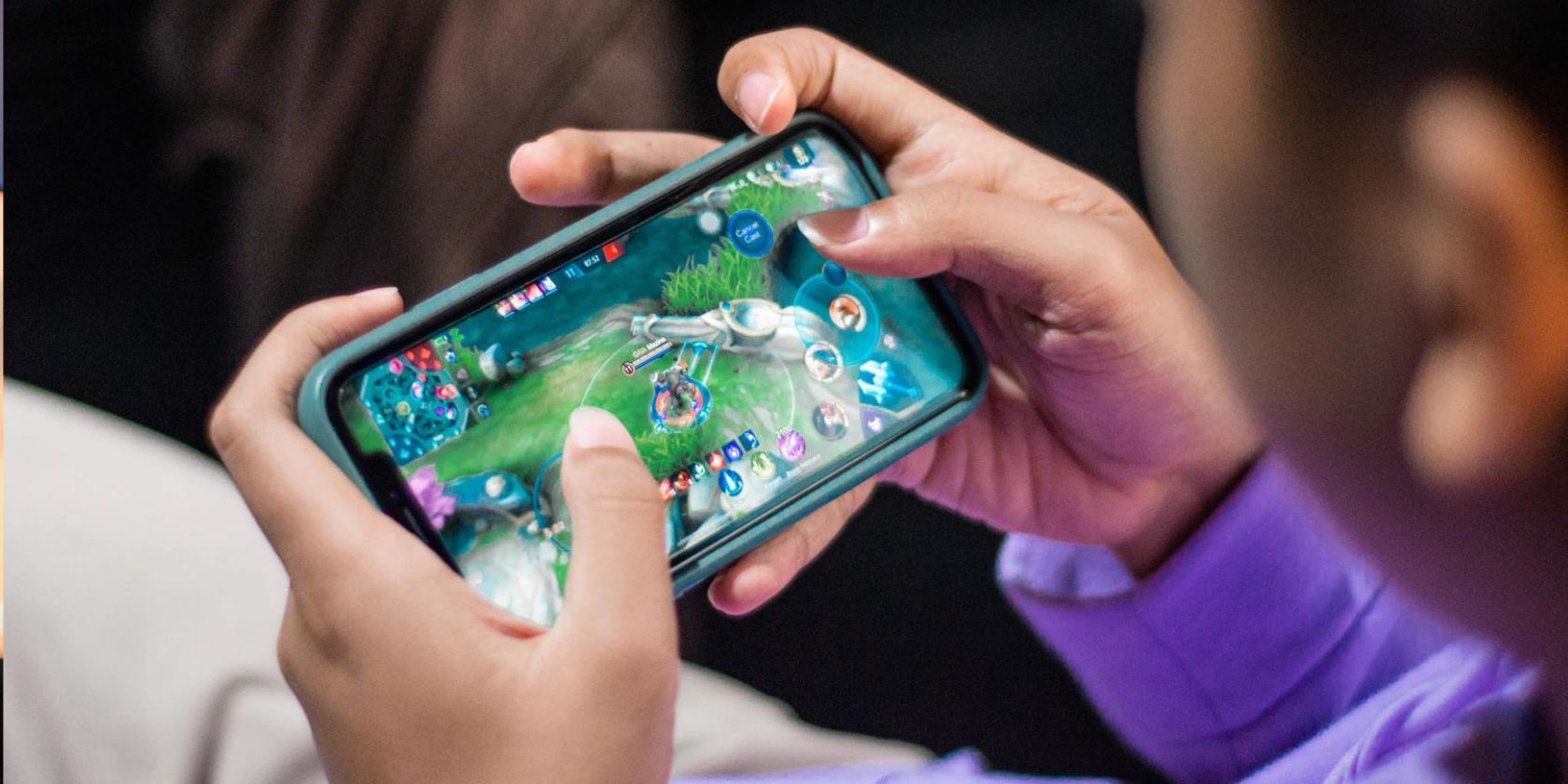 Person playing video games on mobile