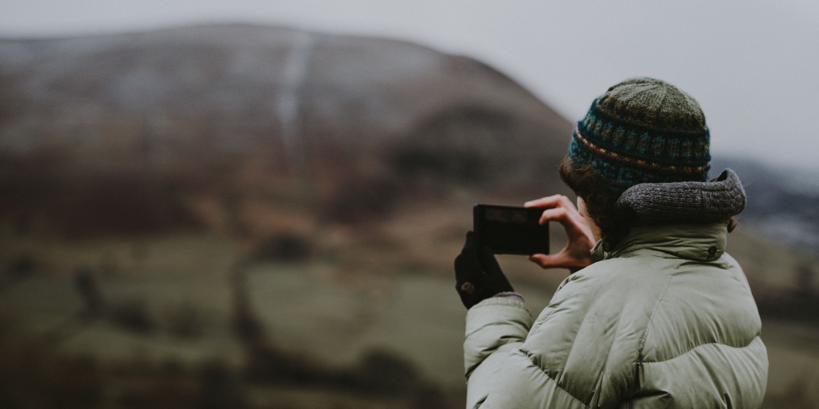 Photo of someone photographing a national park with their smartphone