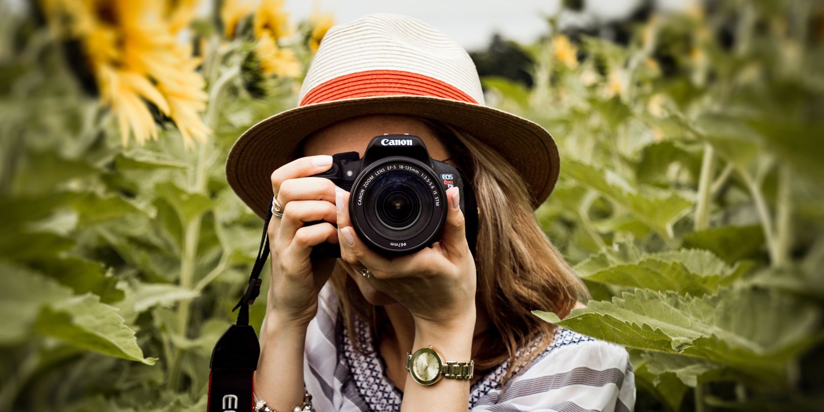 photo of a woman holding a camera in their hands
