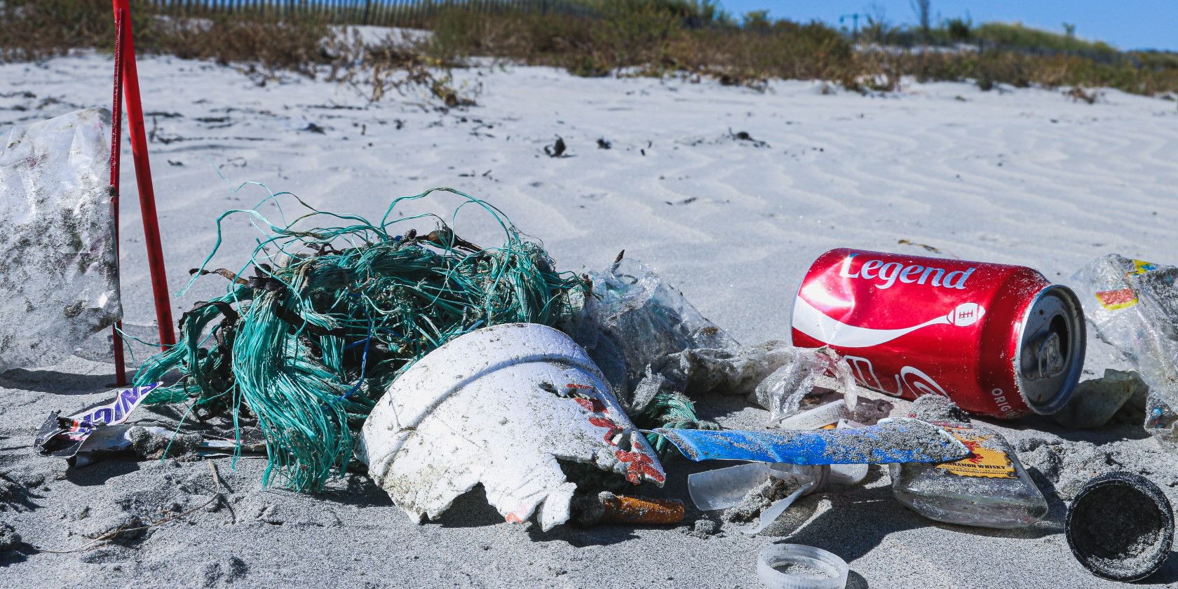 Garbage soda can fishing nets lying on beach