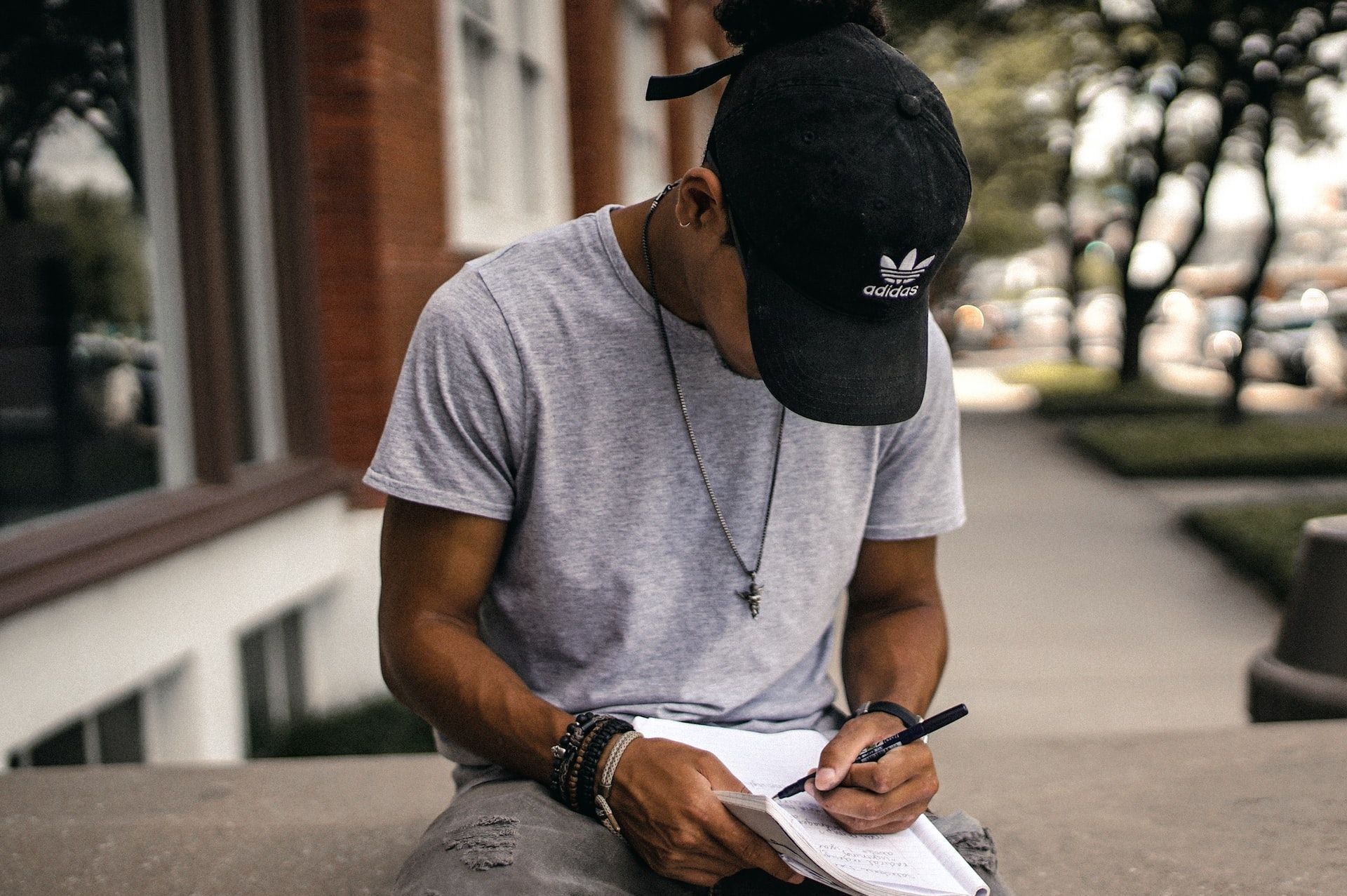 Black Boy Writing on Paper