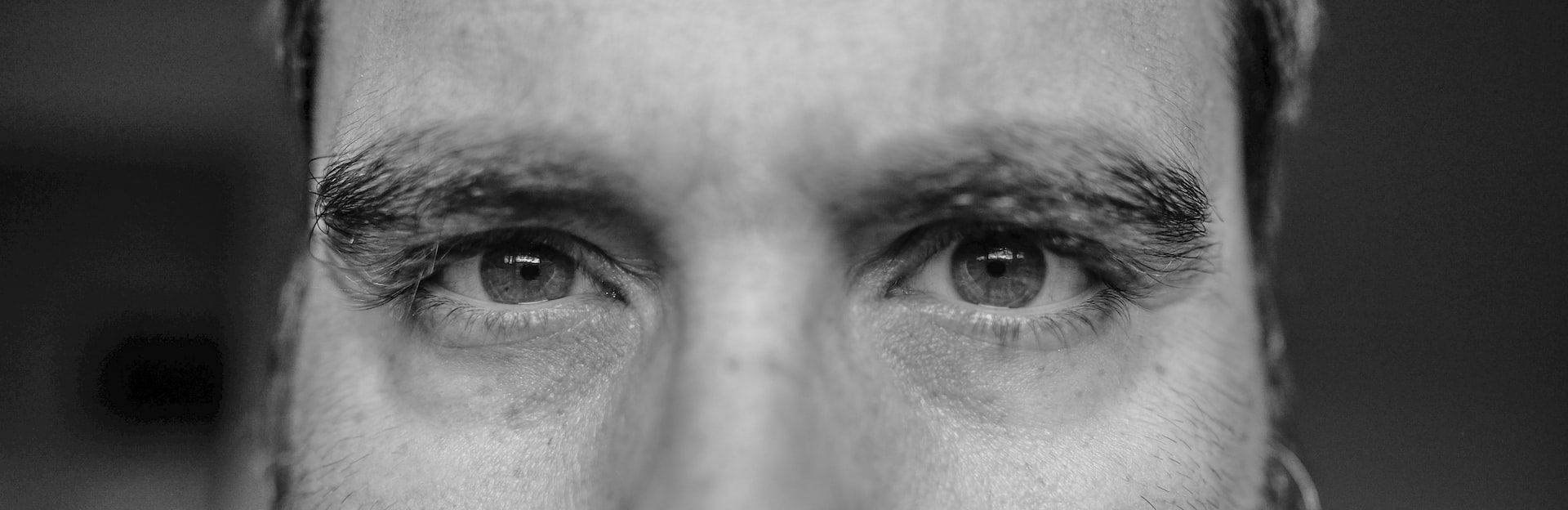 Extreme close-up of a mans eyes in black and white.