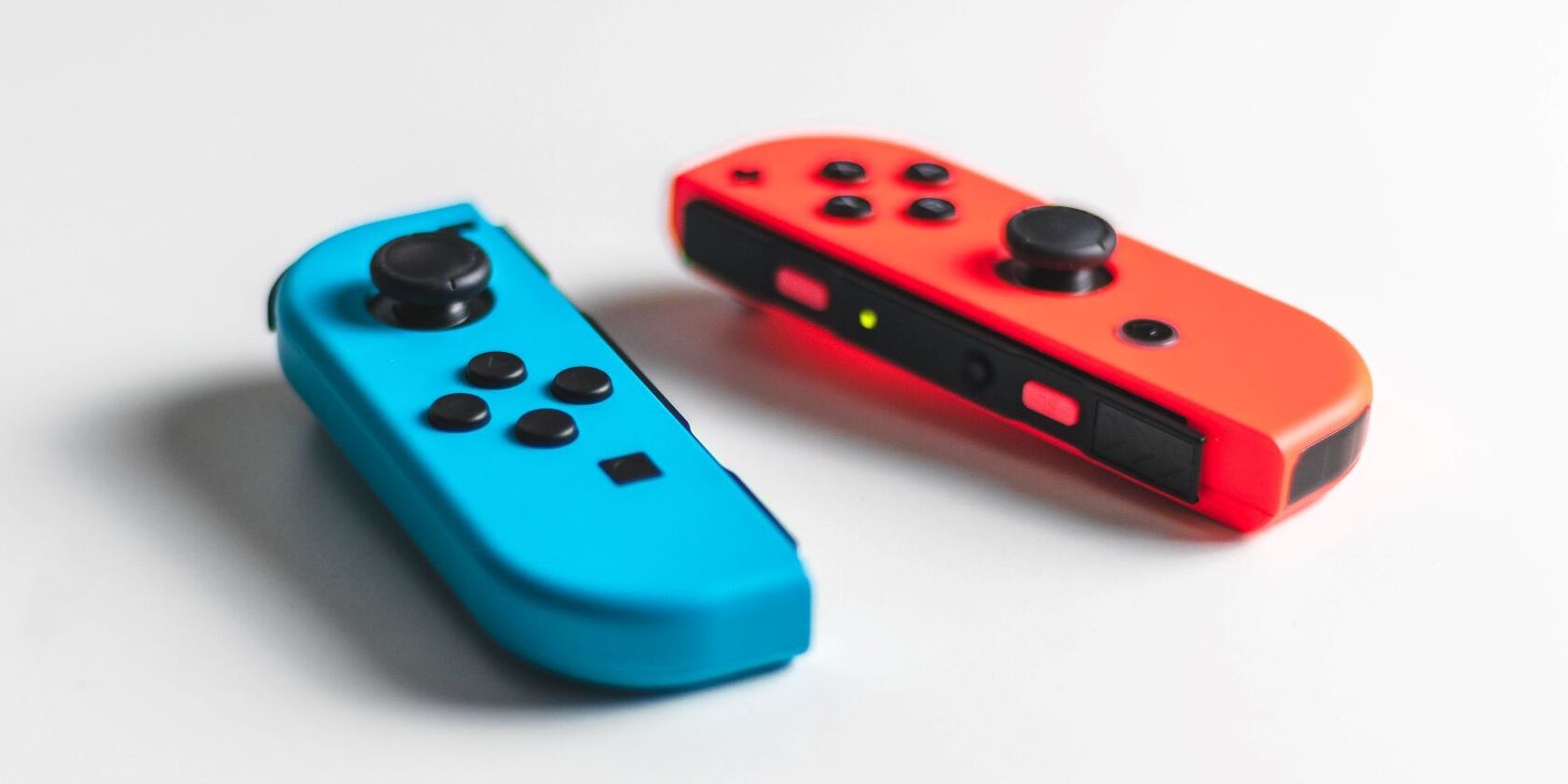 A top down perspective of a set of red and blue Nintendo Joy Cons 