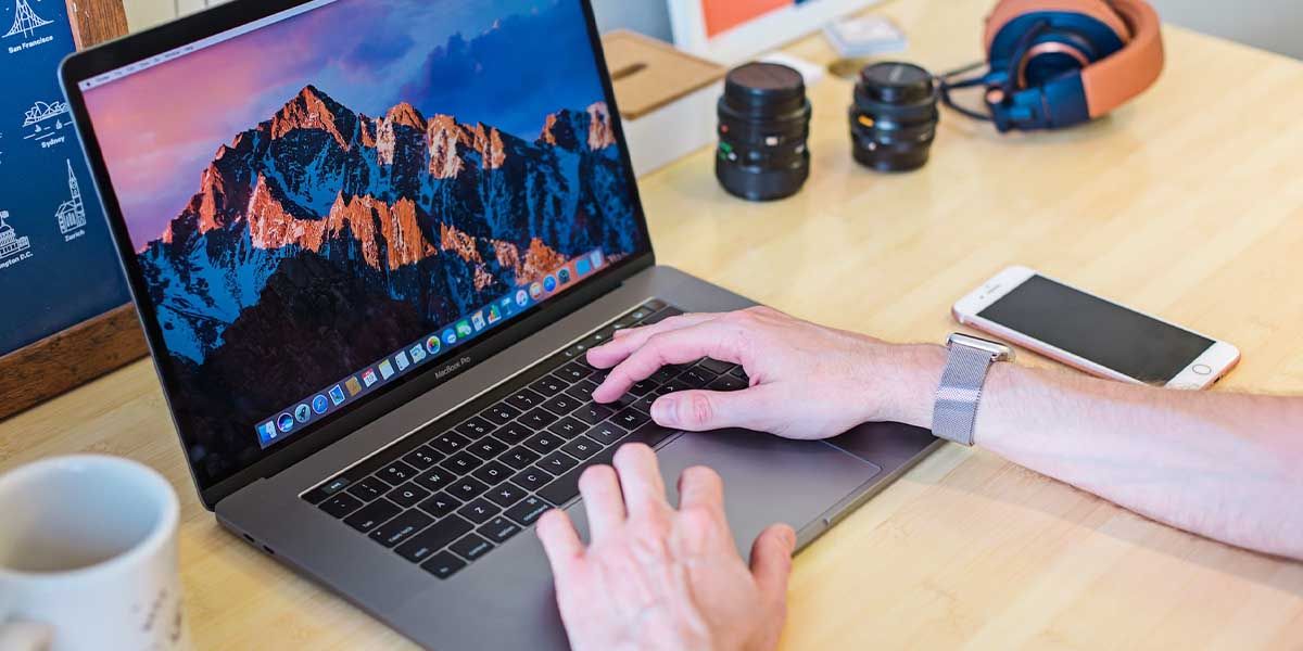 Man's hands using MacBook with immersive experience