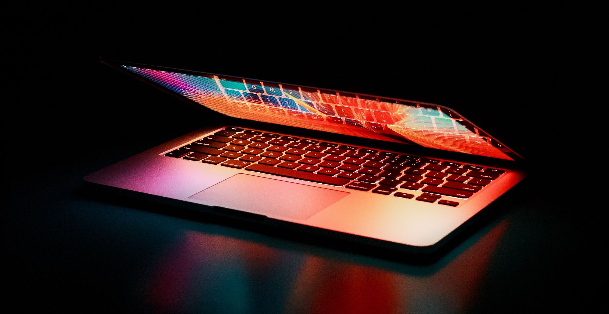 lit up laptop screen in dark room
