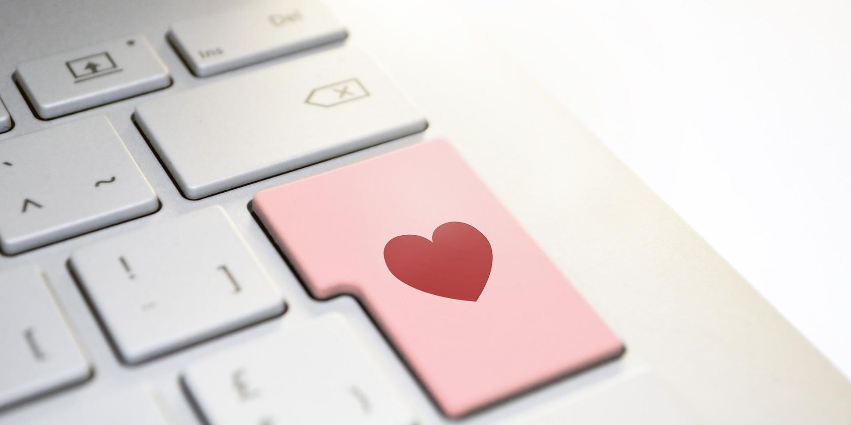 A keyboard with a love heart on the enter key