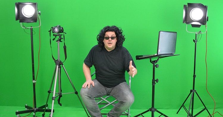 man in front of green screen for video shoot