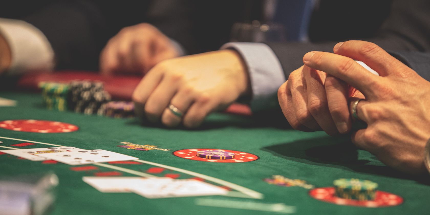 men sitting around a gambling table