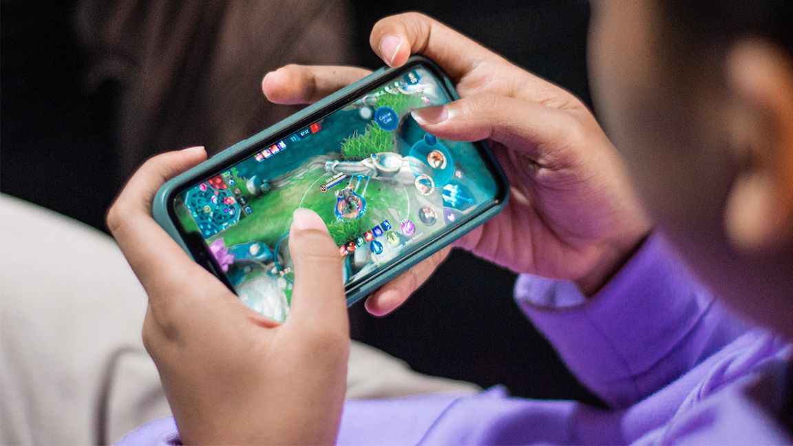 A boy playing a mobile game. 