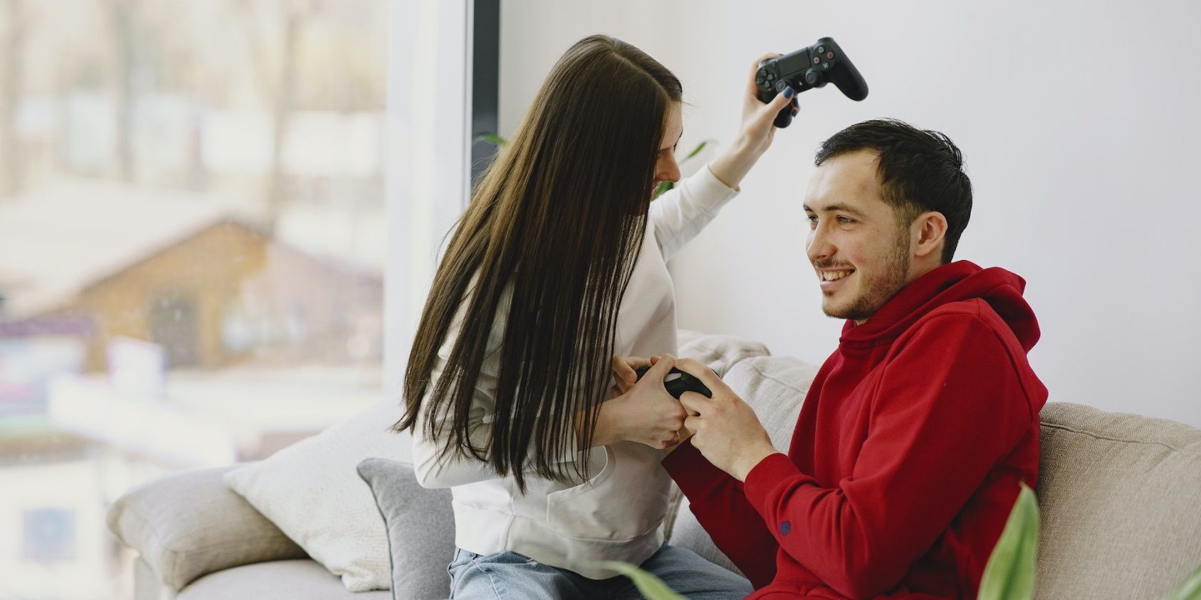 A happy couple holding video game controllers