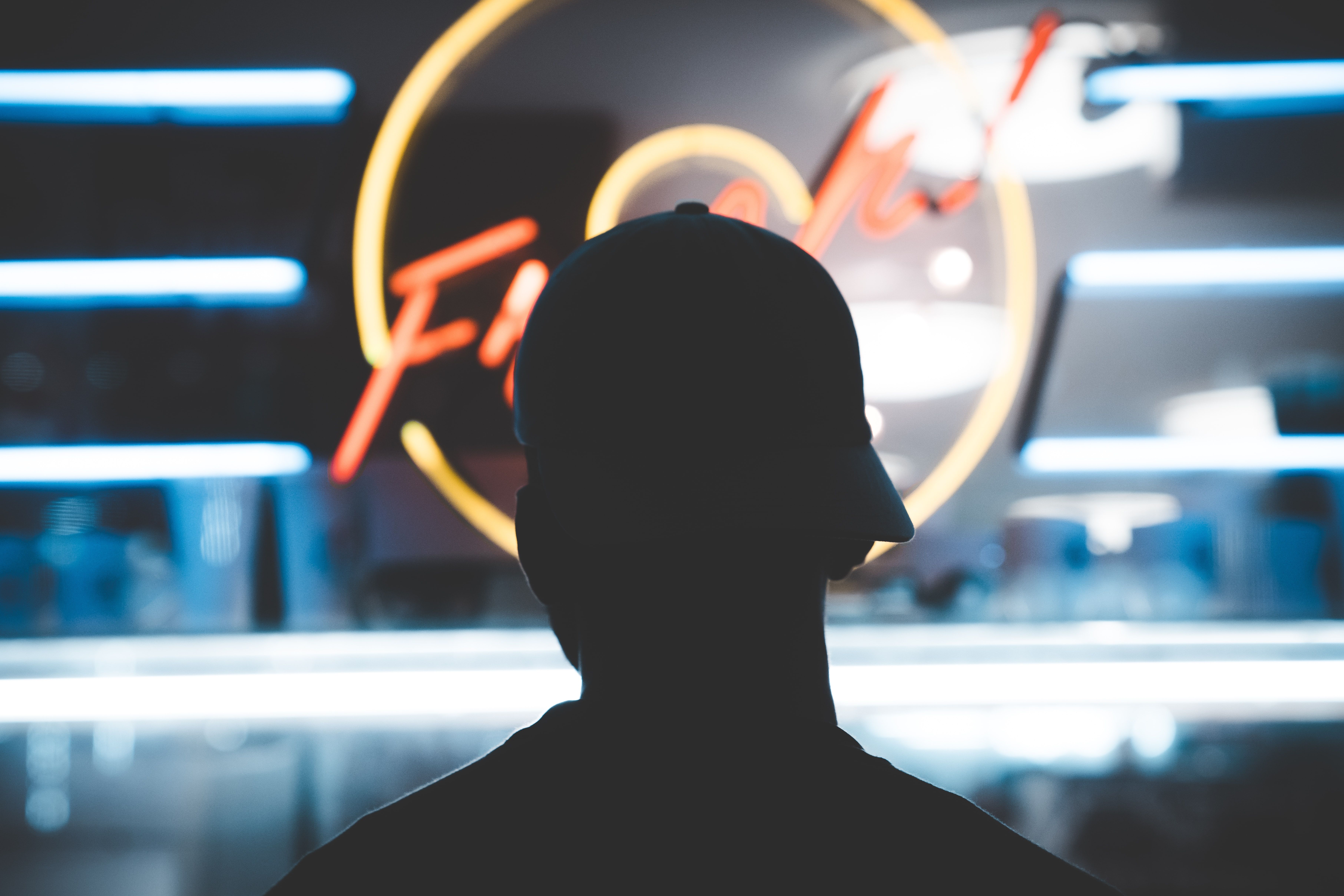 photo of a person in front of a neon sign
