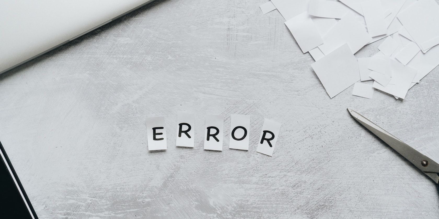 Individual letters on small pieces of paper spell out the word “Error”