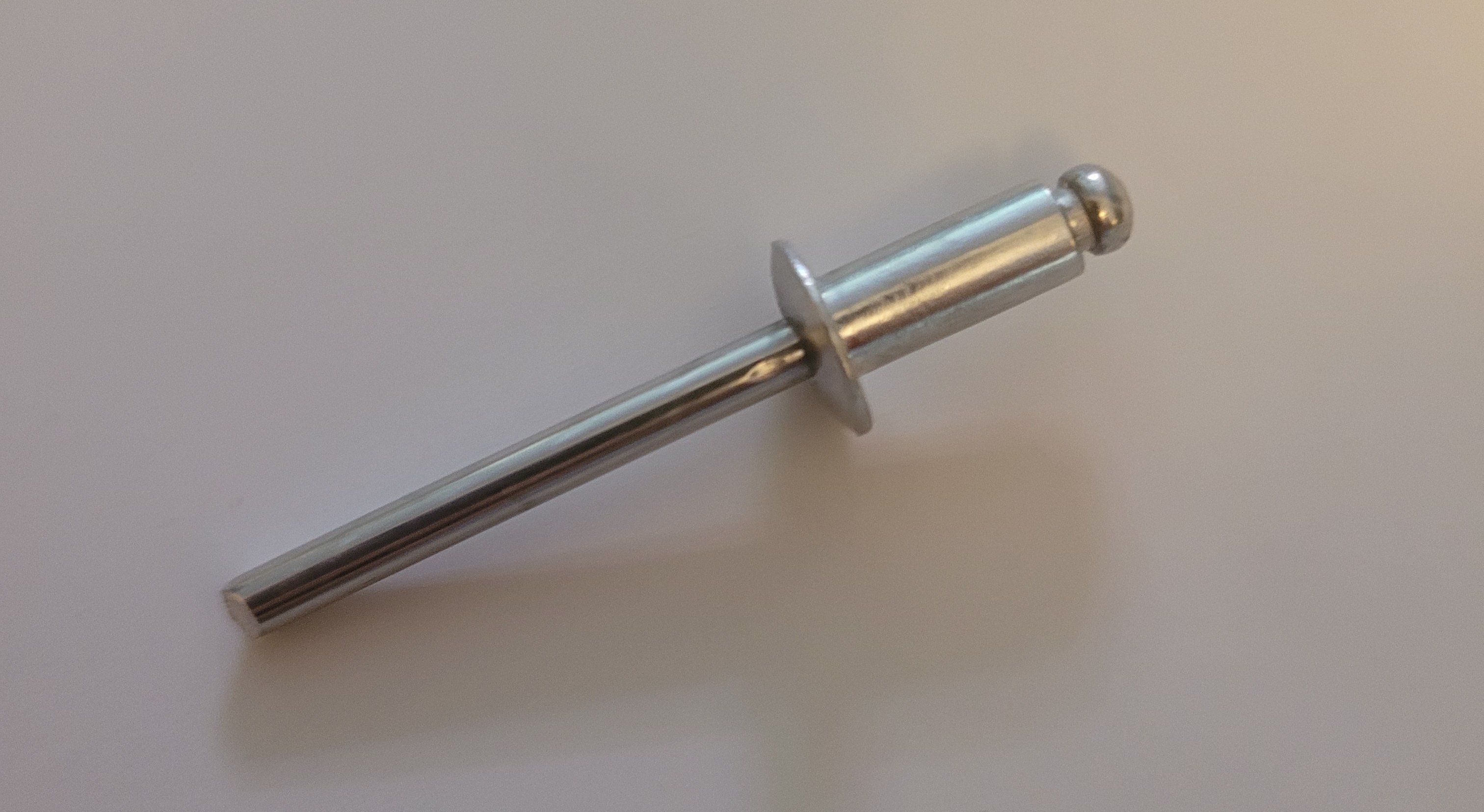A pop rivet against a light background