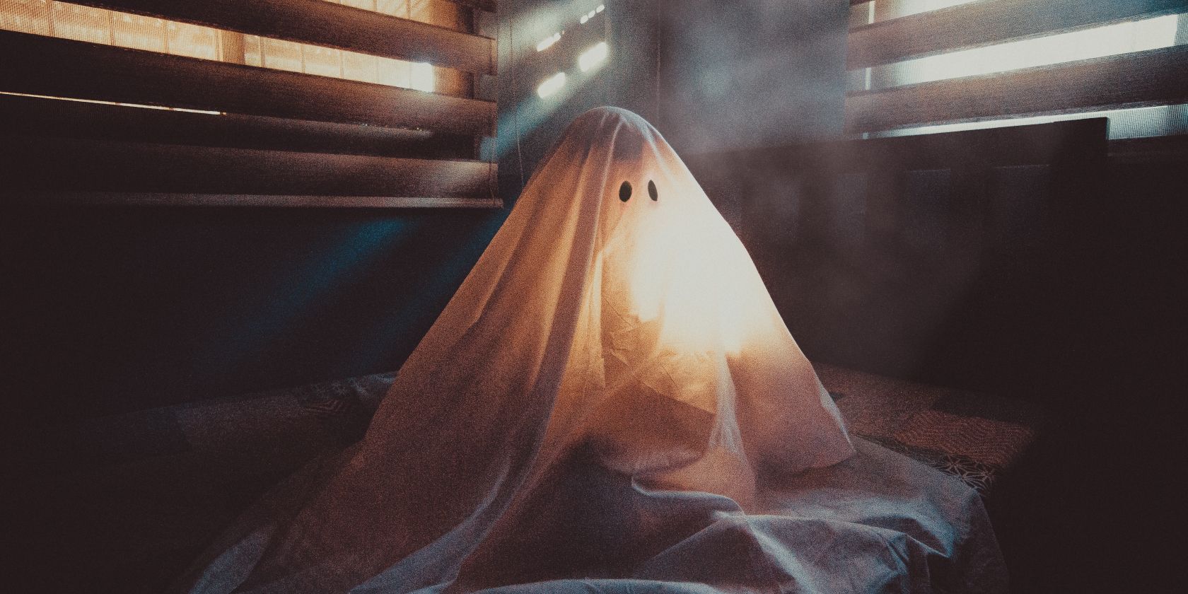 grainy image of a spooky ghost which is really a person under a blanket