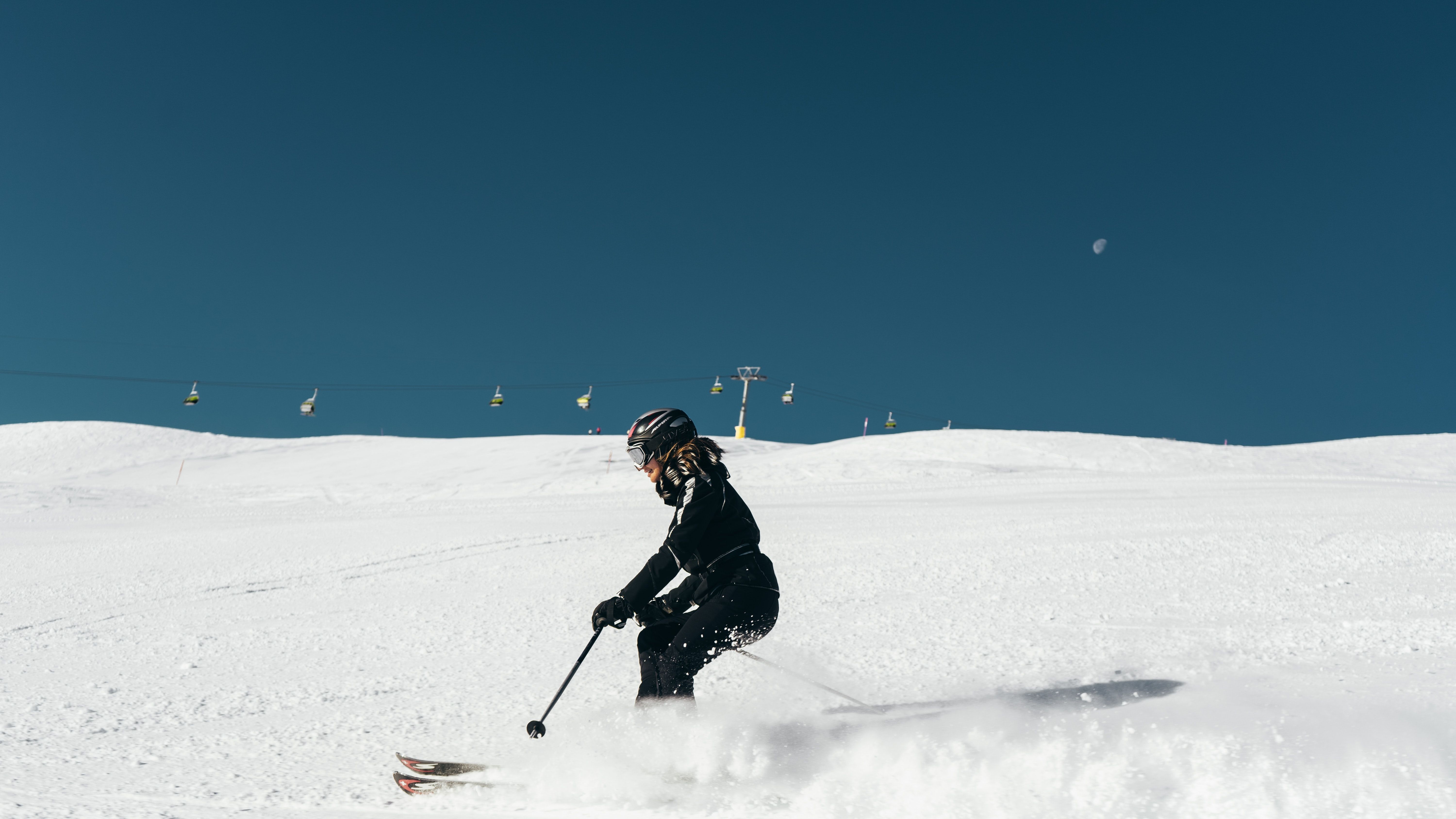 photo of a person skiing on a mountain slope 