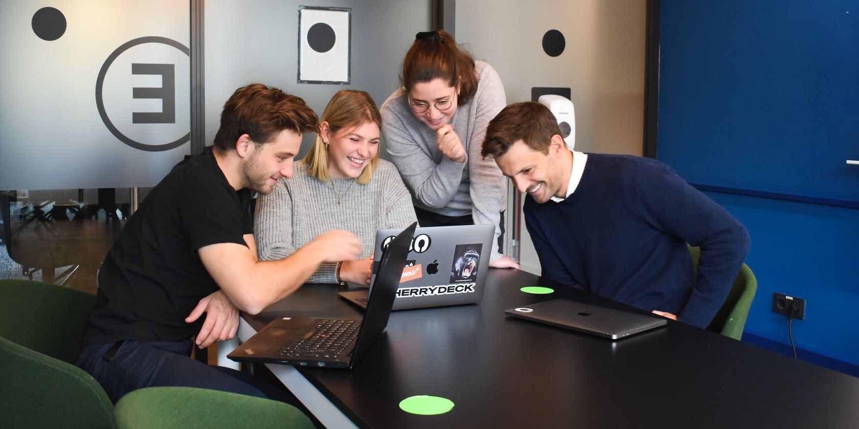 Team at Work around apple laptop