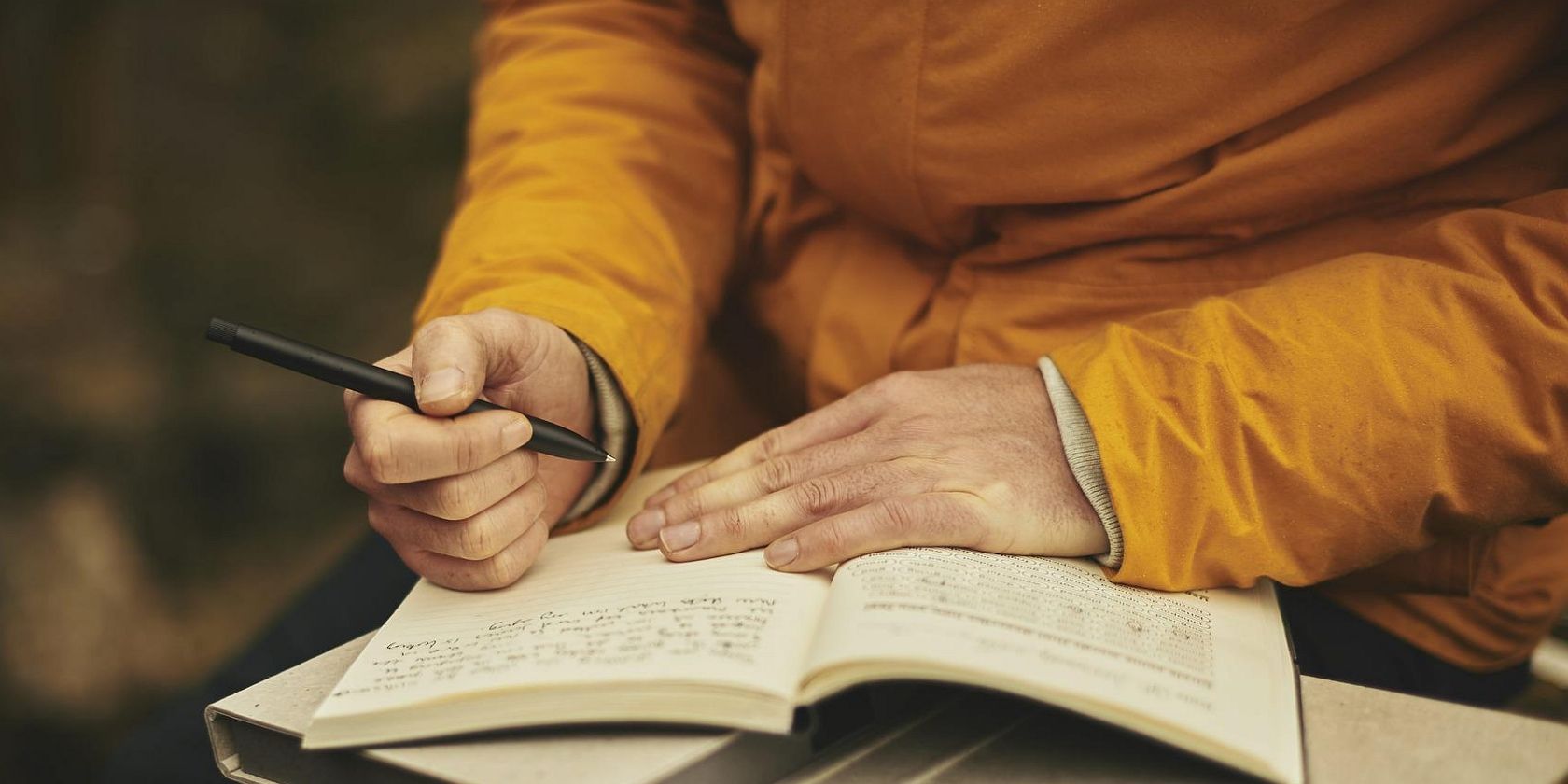 a picture showing someone writing in a book