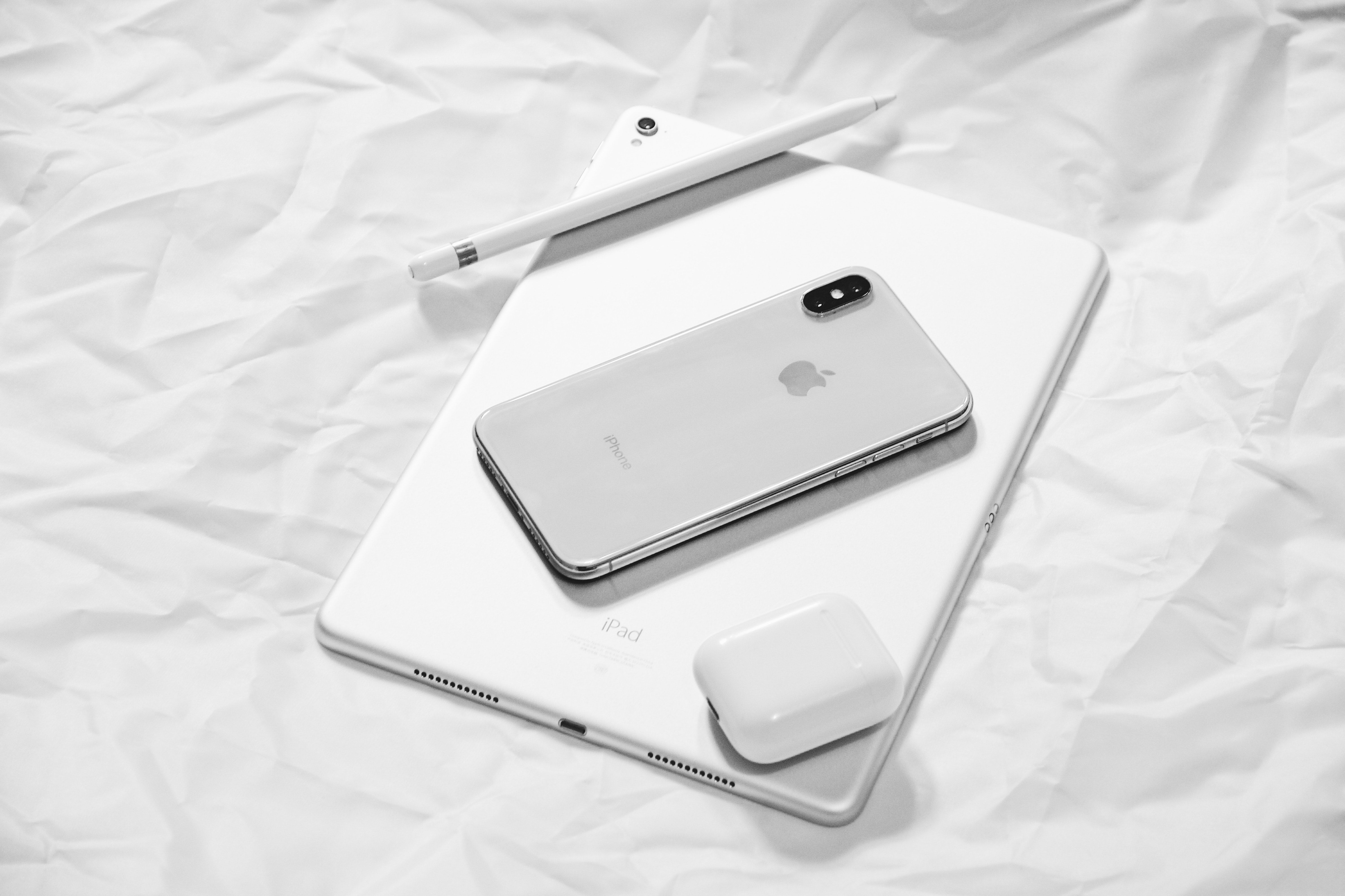 photo of an ipad and iphone together with some airpods 