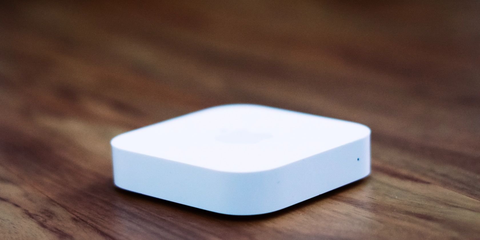 A white MiFi device on a wooden surface