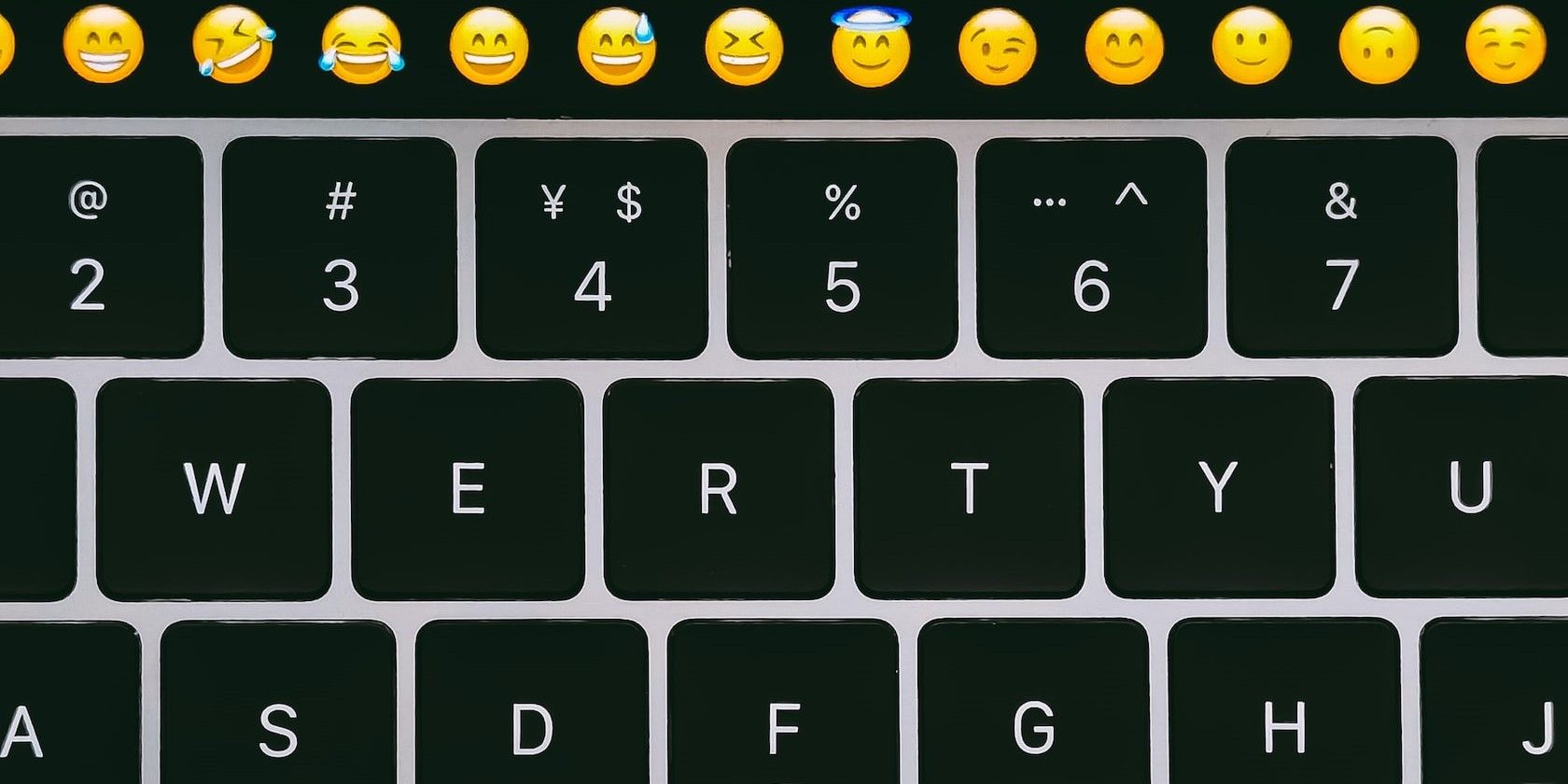 Close Up of Laptop Keyboard with Emojis on the Top Row