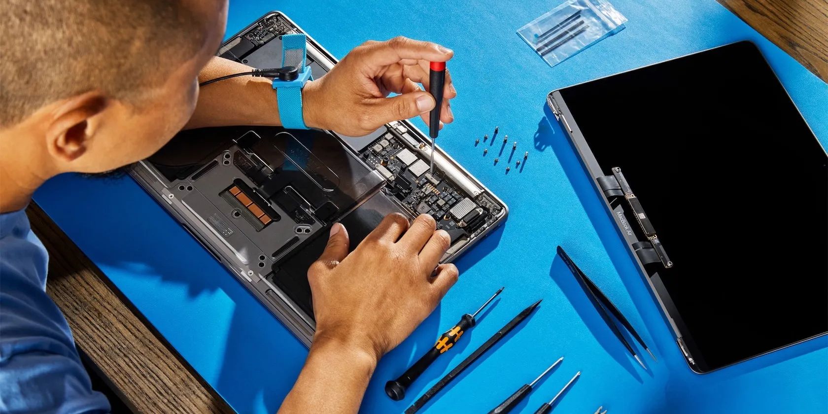 A technician repairing a MacBook