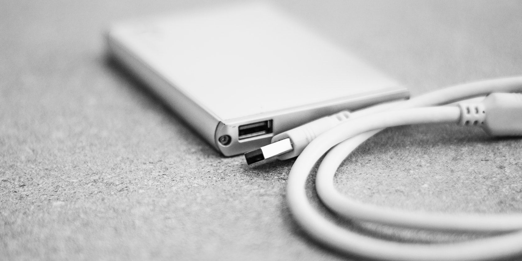 Close-up of a hard drive and a USB cord