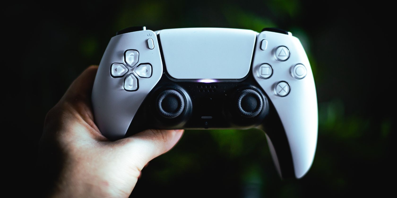 Close up of PS5 DualSense controller against green background